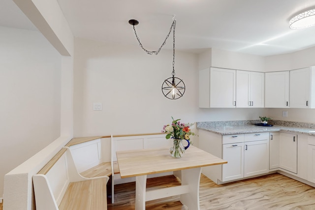 1825 Hiawatha Ct NE, Albuquerque, NM 87112 - kitchen featuring white cabinets and pendant lighting