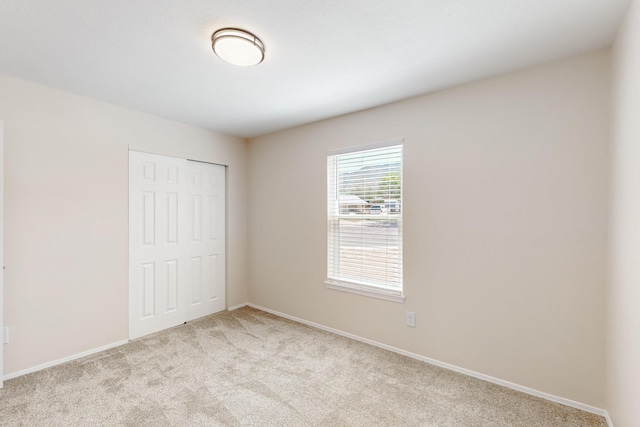 1825 Hiawatha Ct NE, Albuquerque, NM 87112 - unfurnished bedroom with light carpet, a closet, and baseboards