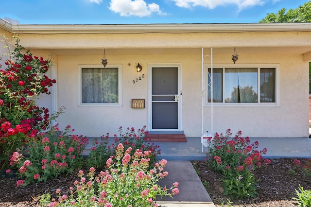 9722 Apache Ave NE, Albuquerque, NM 87112 - doorway to property with a porch and stucco siding