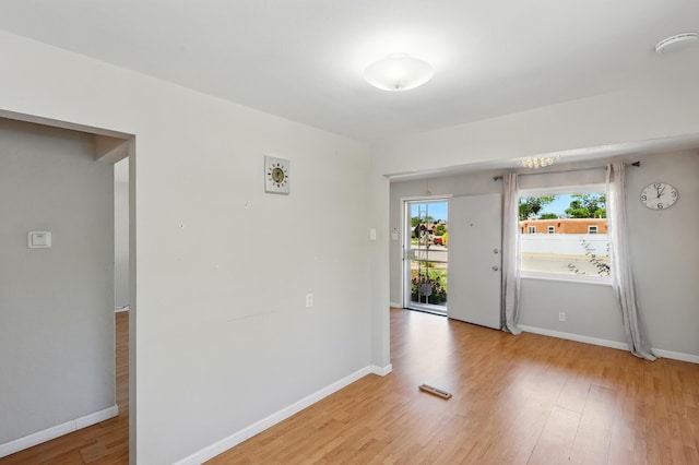 9722 Apache Ave NE, Albuquerque, NM 87112 - empty room with light wood-style flooring, a smoke detector, and baseboards