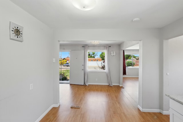 9722 Apache Ave NE, Albuquerque, NM 87112 - unfurnished room featuring light wood-style flooring, baseboards, and a smoke detector