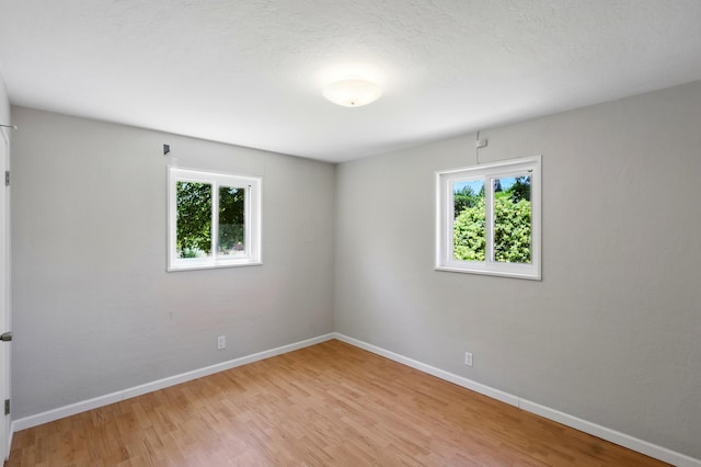 9722 Apache Ave NE, Albuquerque, NM 87112 - unfurnished room featuring plenty of natural light, light wood-style floors, and baseboards