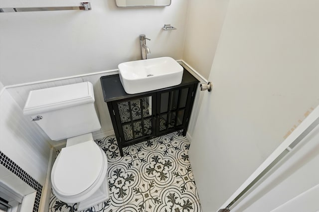 9722 Apache Ave NE, Albuquerque, NM 87112 - bathroom with vanity, toilet, and wainscoting