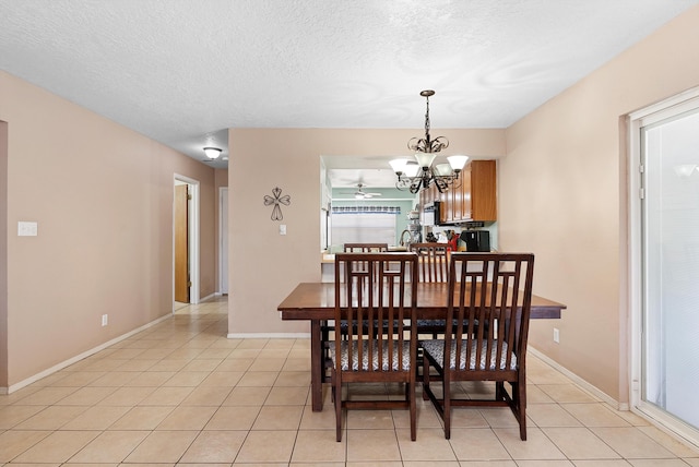 437 7th Ave NE, Rio Rancho, NM 87124 - dining room with light tile patterned floors, a chandelier, a textured ceiling, and baseboards