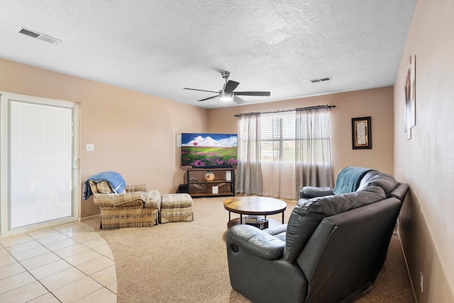 437 7th Ave NE, Rio Rancho, NM 87124 - carpeted living area with a ceiling fan, a textured ceiling, and tile patterned floors