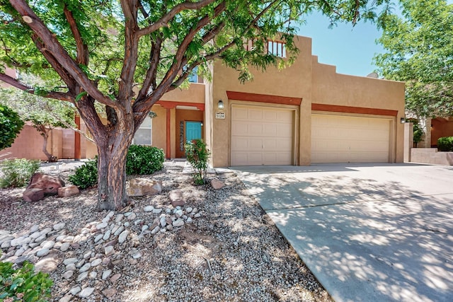 5124 Pyrite Pl NW, Albuquerque, NM 87114 - adobe home with driveway, stucco siding, and an attached garage