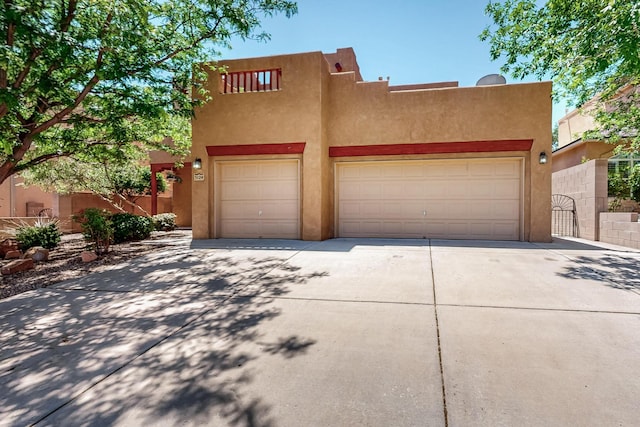 5124 Pyrite Pl NW, Albuquerque, NM 87114 - pueblo-style home with concrete driveway and stucco siding
