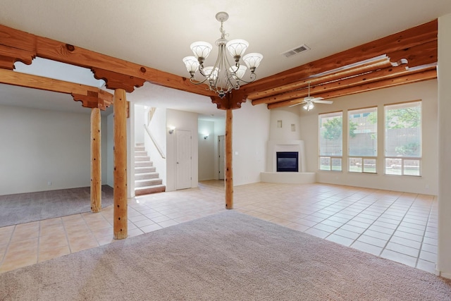 5124 Pyrite Pl NW, Albuquerque, NM 87114 - unfurnished living room with tile patterned floors, carpet, a glass covered fireplace, a chandelier, and a ceiling fan