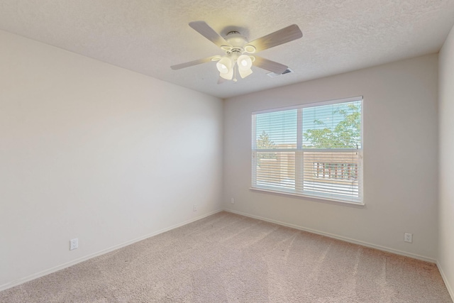 5124 Pyrite Pl NW, Albuquerque, NM 87114 - spare room featuring light colored carpet, baseboards, ceiling fan, and a textured ceiling