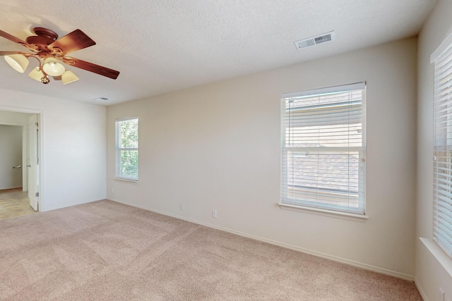 5124 Pyrite Pl NW, Albuquerque, NM 87114 - spare room with light colored carpet, ceiling fan, baseboards, and a textured ceiling