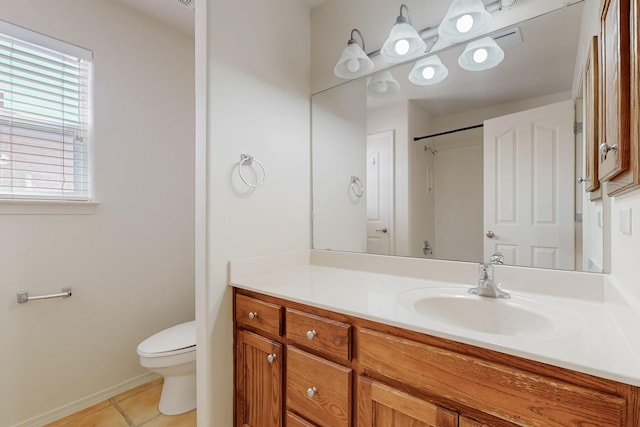 5124 Pyrite Pl NW, Albuquerque, NM 87114 - bathroom with toilet, vanity, tile patterned flooring, and baseboards
