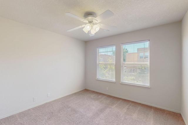 5124 Pyrite Pl NW, Albuquerque, NM 87114 - spare room with light colored carpet, a ceiling fan, baseboards, and a textured ceiling