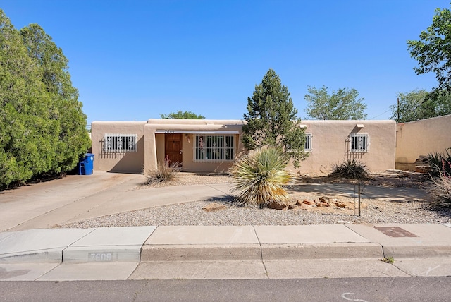7609 Hannett Ave NE, Albuquerque, NM 87110 - southwest-style home featuring stucco siding and concrete driveway