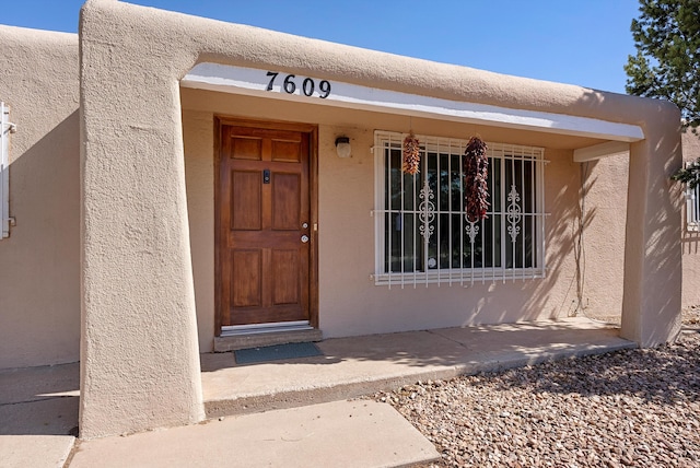 7609 Hannett Ave NE, Albuquerque, NM 87110 - entrance to property featuring stucco siding