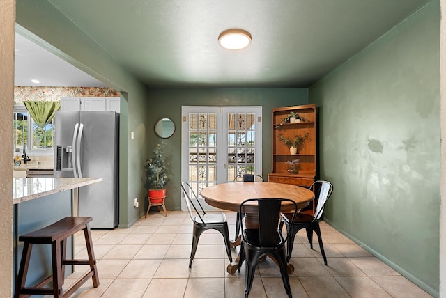 7609 Hannett Ave NE, Albuquerque, NM 87110 - dining room featuring light tile patterned floors and baseboards
