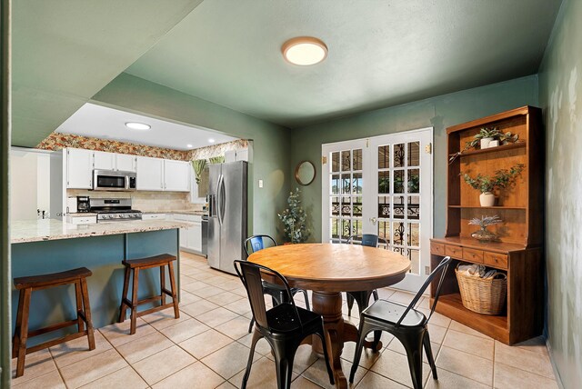7609 Hannett Ave NE, Albuquerque, NM 87110 - dining space featuring french doors and light tile patterned floors