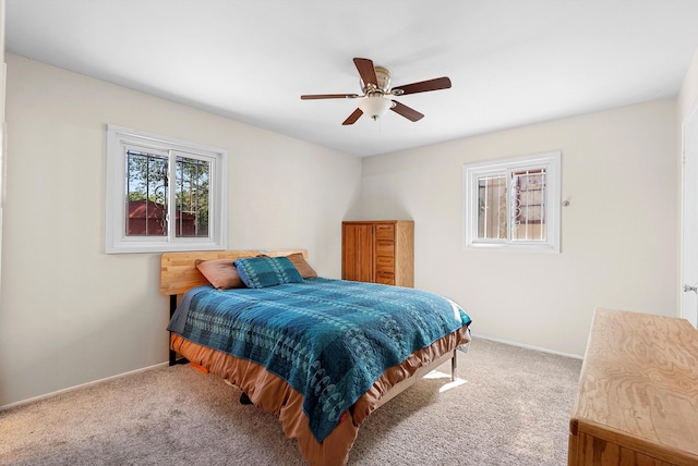 7609 Hannett Ave NE, Albuquerque, NM 87110 - carpeted bedroom with baseboards and a ceiling fan