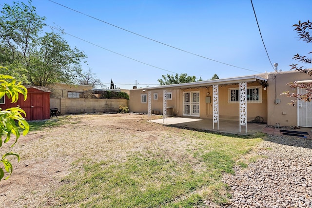 7609 Hannett Ave NE, Albuquerque, NM 87110 - rear view of property featuring stucco siding, a patio area, and central air condition unit