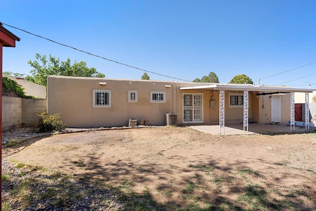 7609 Hannett Ave NE, Albuquerque, NM 87110 - rear view of property featuring a patio and stucco siding