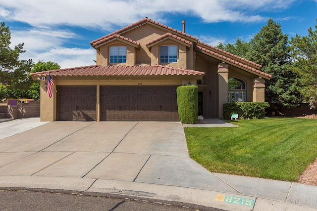 8215 Corona Ave NE, Albuquerque, NM 87122 - mediterranean / spanish-style home with stucco siding, a front lawn, a tiled roof, an attached garage, and concrete driveway