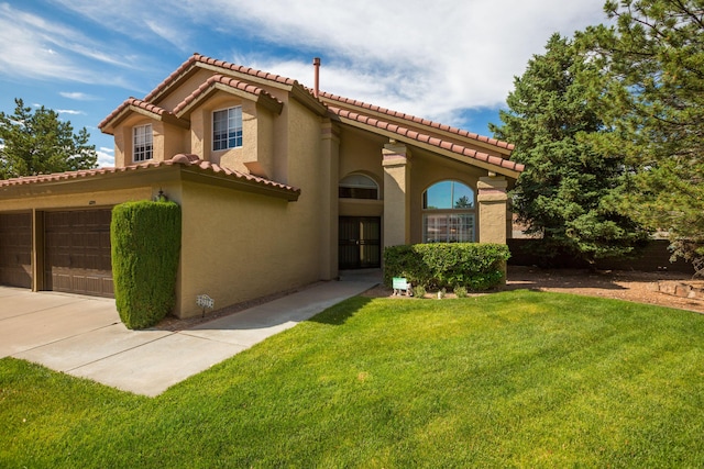8215 Corona Ave NE, Albuquerque, NM 87122 - mediterranean / spanish-style home featuring a tiled roof, stucco siding, a front lawn, and driveway