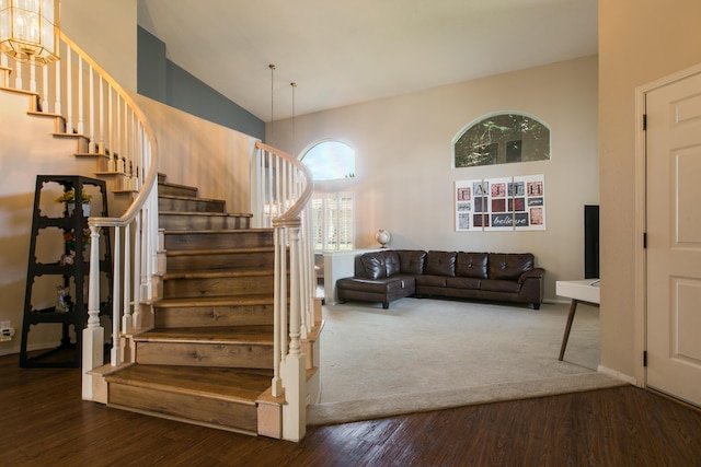 8215 Corona Ave NE, Albuquerque, NM 87122 - stairway with wood finished floors, high vaulted ceiling, and baseboards