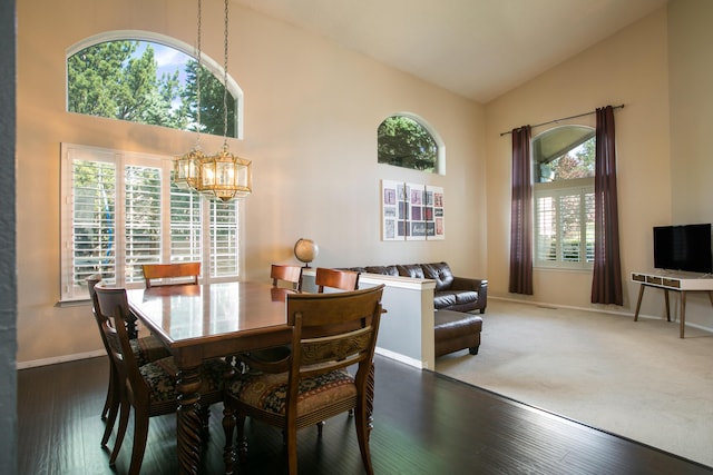 8215 Corona Ave NE, Albuquerque, NM 87122 - dining space featuring a chandelier, high vaulted ceiling, baseboards, and wood finished floors