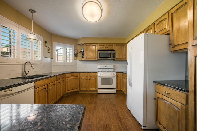 8215 Corona Ave NE, Albuquerque, NM 87122 - kitchen with white appliances, a sink, brown cabinetry, tasteful backsplash, and dark wood-type flooring