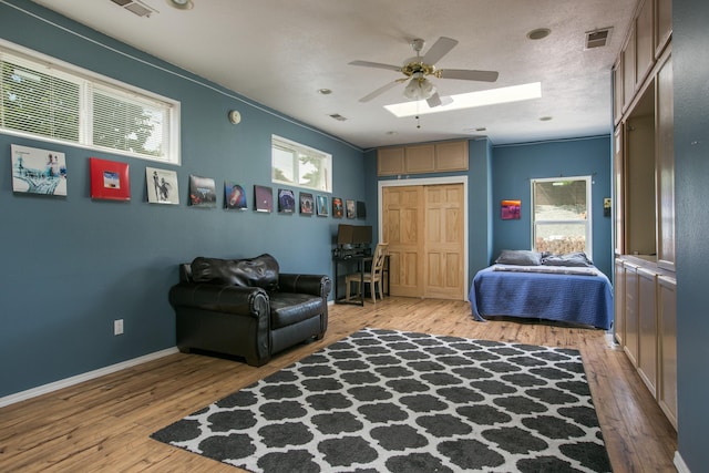 8215 Corona Ave NE, Albuquerque, NM 87122 - sitting room with plenty of natural light, light wood-type flooring, ceiling fan, and baseboards