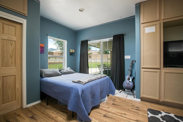 8215 Corona Ave NE, Albuquerque, NM 87122 - bedroom featuring light wood-type flooring, access to outside, and baseboards