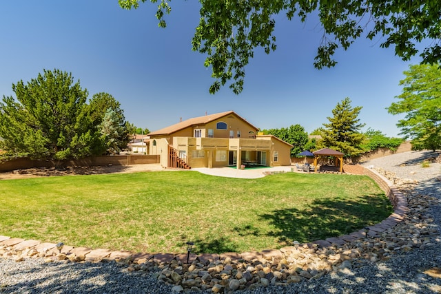 8215 Corona Ave NE, Albuquerque, NM 87122 - back of property with a gazebo, a patio area, stairs, and stucco siding