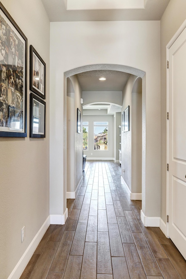 6240 Redroot St, Albuquerque, NM 87120 - corridor with arched walkways, dark wood-style floors, and baseboards