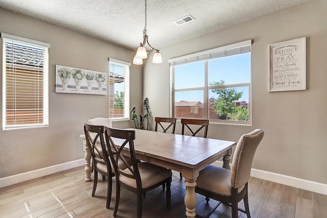 6240 Redroot St, Albuquerque, NM 87120 - dining space featuring baseboards, light wood-type flooring, and a textured ceiling