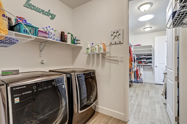 6240 Redroot St, Albuquerque, NM 87120 - laundry room with washer and clothes dryer, baseboards, and light wood-style floors