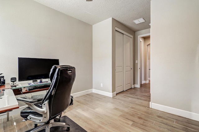 6240 Redroot St, Albuquerque, NM 87120 - office area featuring light wood-style floors, baseboards, and a textured ceiling