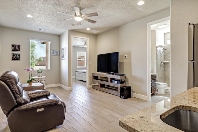 6240 Redroot St, Albuquerque, NM 87120 - living room featuring ceiling fan, baseboards, a textured ceiling, light wood-style flooring, and recessed lighting