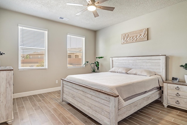 6240 Redroot St, Albuquerque, NM 87120 - bedroom featuring wood tiled floors, a textured ceiling, baseboards, and a ceiling fan