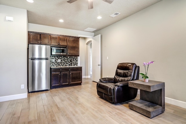 6240 Redroot St, Albuquerque, NM 87120 - sitting room featuring arched walkways, light wood-type flooring, a ceiling fan, baseboards, and recessed lighting