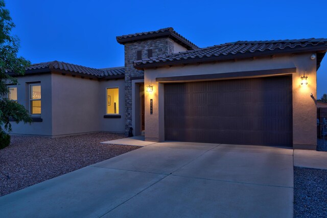 6240 Redroot St, Albuquerque, NM 87120 - mediterranean / spanish house featuring a tiled roof, stucco siding, a garage, and driveway