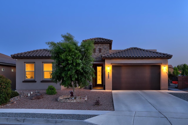 6240 Redroot St, Albuquerque, NM 87120 - mediterranean / spanish house featuring an attached garage, concrete driveway, stucco siding, and a tile roof