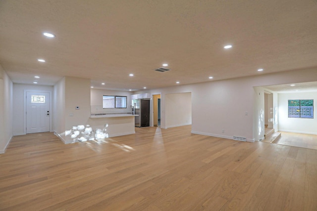 3217 Tennessee St NE, Albuquerque, NM 87110 - unfurnished living room featuring light wood-type flooring, recessed lighting, and baseboards