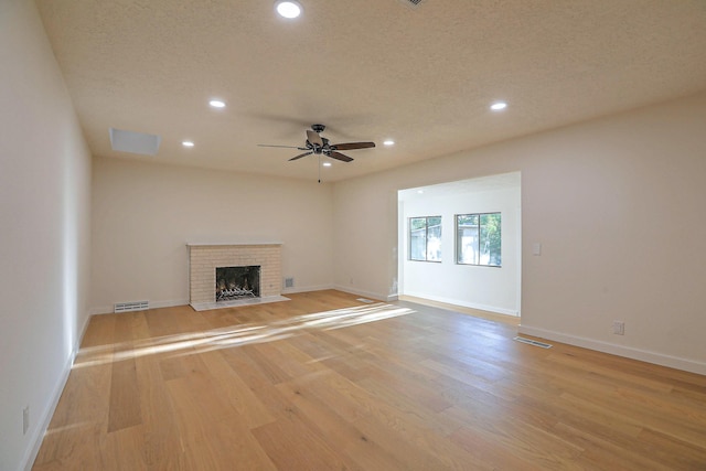 3217 Tennessee St NE, Albuquerque, NM 87110 - unfurnished living room with recessed lighting, light wood-style floors, a brick fireplace, a ceiling fan, and baseboards
