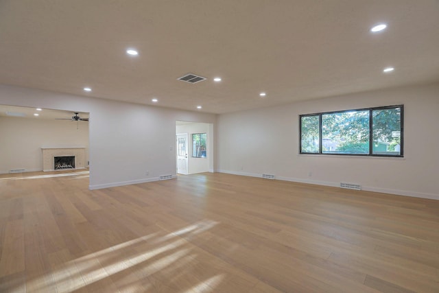 3217 Tennessee St NE, Albuquerque, NM 87110 - unfurnished living room with recessed lighting, light wood finished floors, healthy amount of natural light, a fireplace, and baseboards