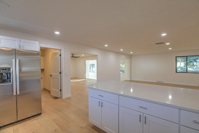 3217 Tennessee St NE, Albuquerque, NM 87110 - kitchen featuring stainless steel refrigerator with ice dispenser, light wood-style flooring, recessed lighting, light stone counters, and open floor plan