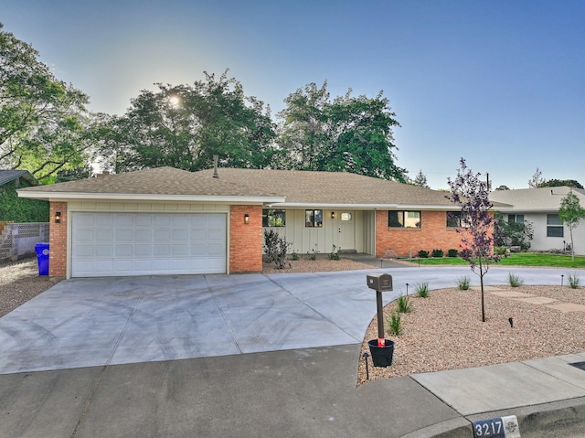 3217 Tennessee St NE, Albuquerque, NM 87110 - ranch-style home featuring brick siding, concrete driveway, and an attached garage