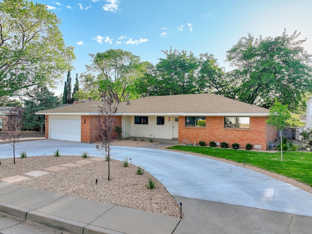 3217 Tennessee St NE, Albuquerque, NM 87110 - single story home with curved driveway, brick siding, a front yard, and an attached garage