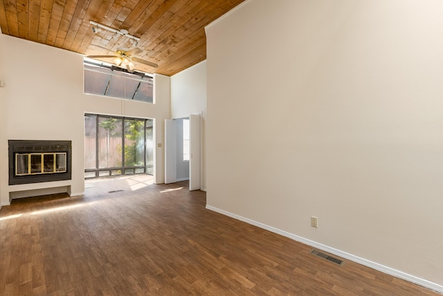 600 Aztec Rd NW, Albuquerque, NM 87107 - unfurnished living room with wooden ceiling, high vaulted ceiling, baseboards, a glass covered fireplace, and wood finished floors