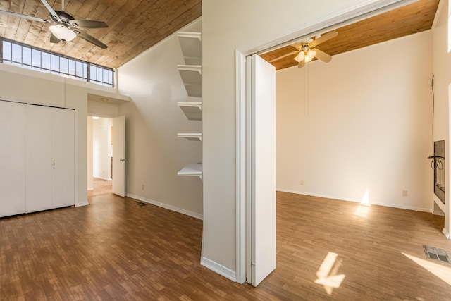 600 Aztec Rd NW, Albuquerque, NM 87107 - unfurnished living room featuring a ceiling fan, wooden ceiling, wood finished floors, a towering ceiling, and baseboards