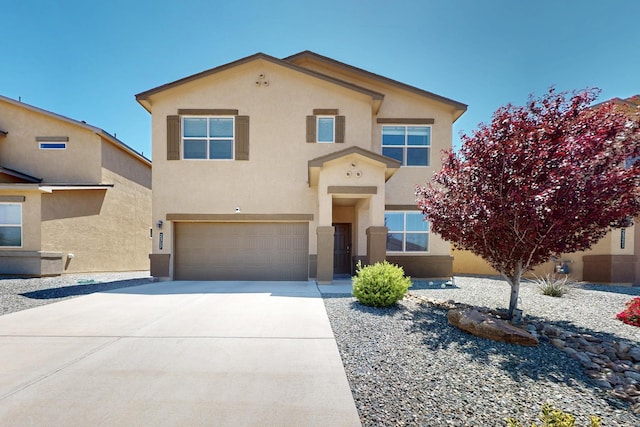 2317 Solara Loop NE, Rio Rancho, NM 87144 - view of front of house featuring stucco siding, an attached garage, and driveway