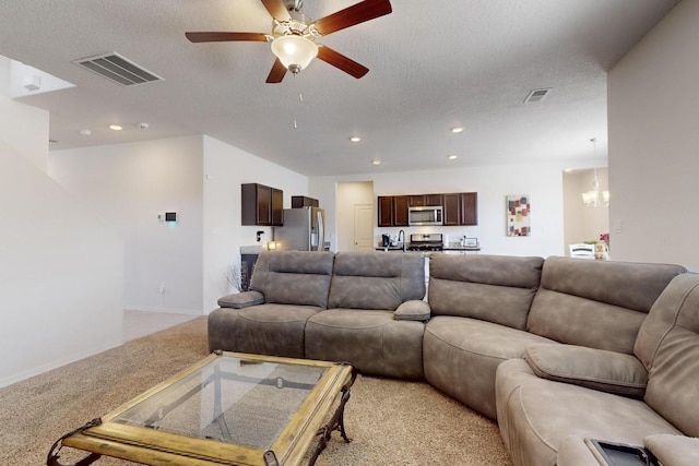 2317 Solara Loop NE, Rio Rancho, NM 87144 - living area with light carpet, a chandelier, ceiling fan, recessed lighting, and a textured ceiling